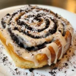 A tray of freshly baked Oreo-Stuffed Cinnamon Rolls drizzled with icing and chocolate.