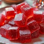 Homemade Red Hot Cinnamon Hard Candy pieces on a baking sheet, dusted with powdered sugar.