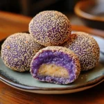 Close-up of Ube Cheese Buchi – Filipino sesame balls with purple yam and cheese filling